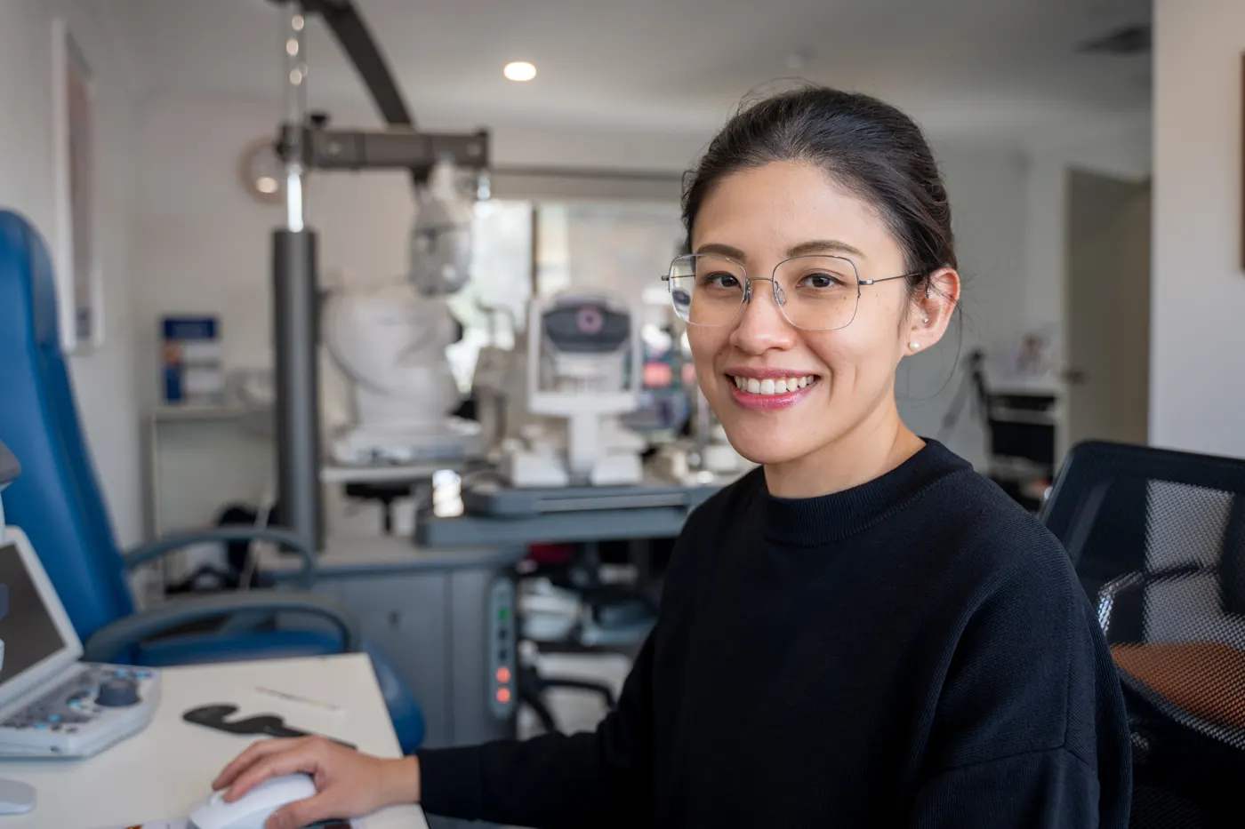 An E Eye Place optometrist at the testing equipment