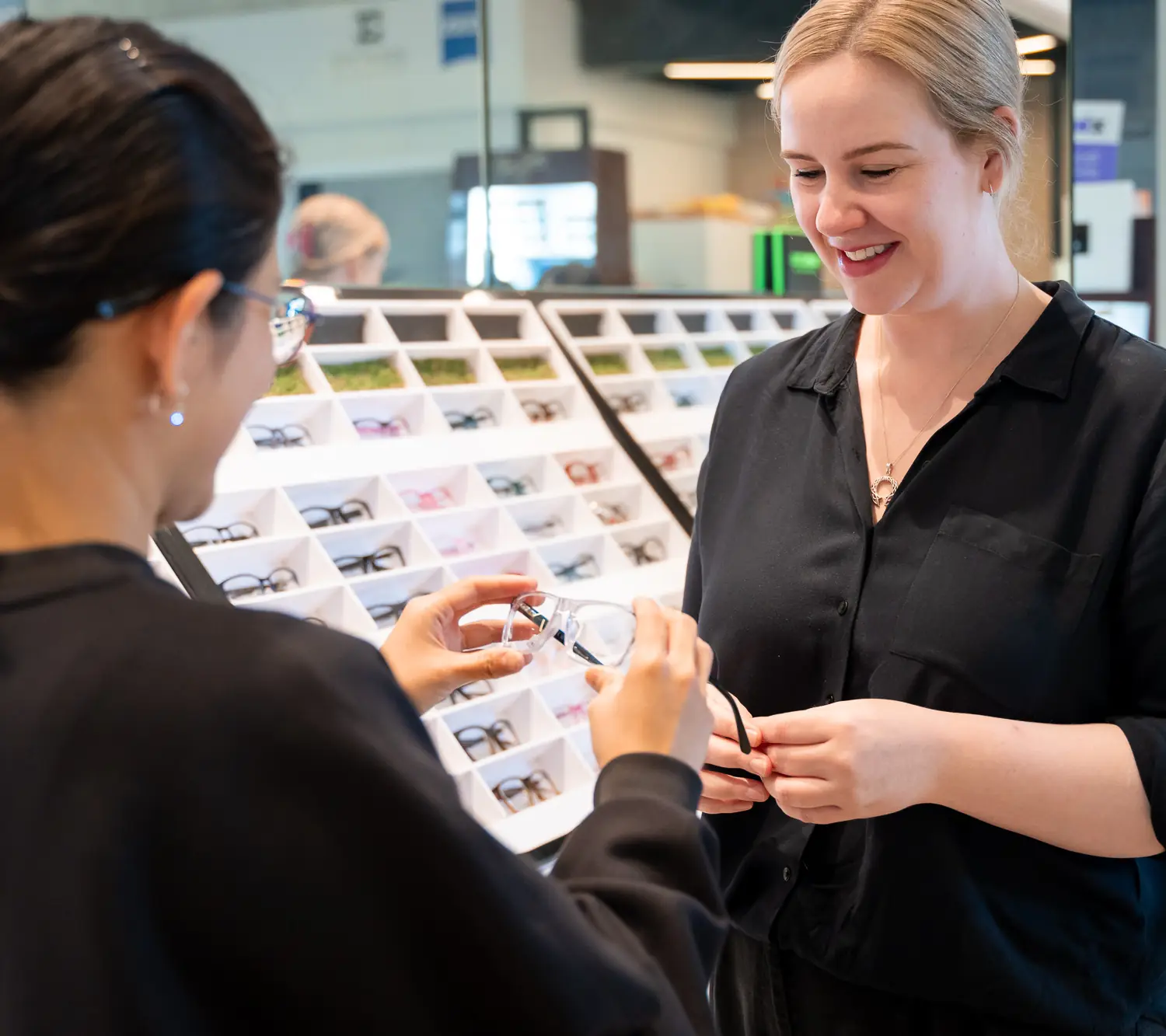 A dispenser helping a patient choose frames at Port Coogee