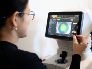 optometrist conducting an eye test on a child