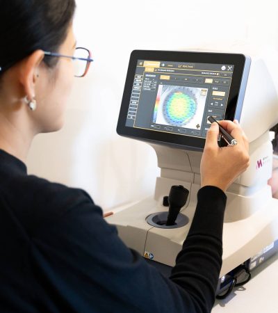 optometrist performing an eye test looking for myopia in the patients eye.